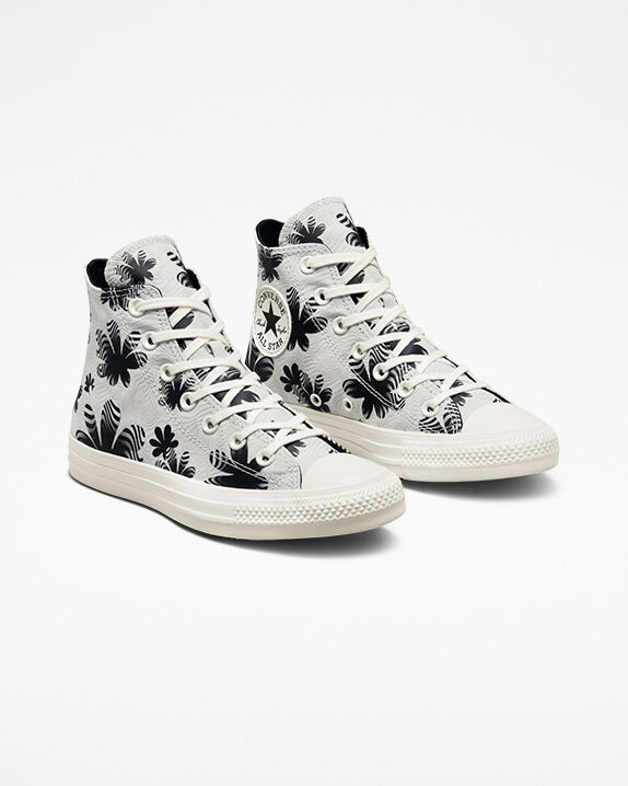 black converse with flowers