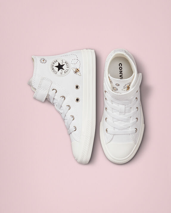white patterned converse