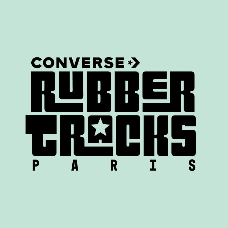 The image features a bold, black graphic text logo on a light green background that reads &ldquo;CONVERSE RUBBER TRACKS PARIS.&rdquo; The design incorporates a star symbol within the letter &ldquo;A&rdquo; in &ldquo;TRACKS,&rdquo; emphasizing the Converse brand identity.