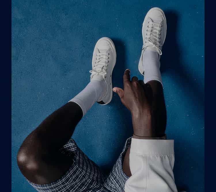 Overhead image of white low top Jack Purcell shoes