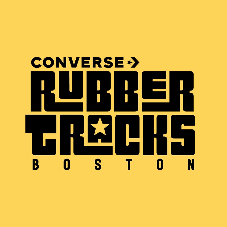 The image features bold black text on a yellow background that reads &ldquo;CONVERSE RUBBER TRACKS BOSTON,&rdquo; with a star symbol integrated into the letter &ldquo;O&rdquo; in &ldquo;TRACKS.&rdquo; It appears to be a logo or promotional graphic for Converse Rubber Tracks, specifically referencing Boston.
