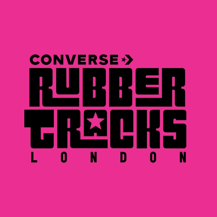 The image features bold black text on a bright pink background that reads &ldquo;CONVERSE RUBBER TRACKS LONDON,&rdquo; with a star symbol integrated into the letter &ldquo;A&rdquo; in &ldquo;TRACKS.&rdquo; It appears to be a logo or promotional graphic for Converse Rubber Tracks London.