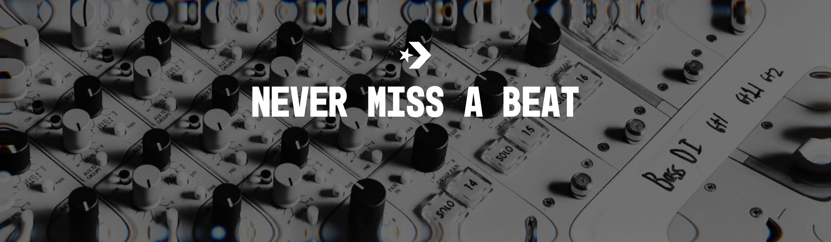 The image shows a close-up of an audio mixing console with various knobs and buttons. Overlaid in the center is bold white text that reads &ldquo;NEVER MISS A BEAT&rdquo; along with a small star and arrow symbol above the text.