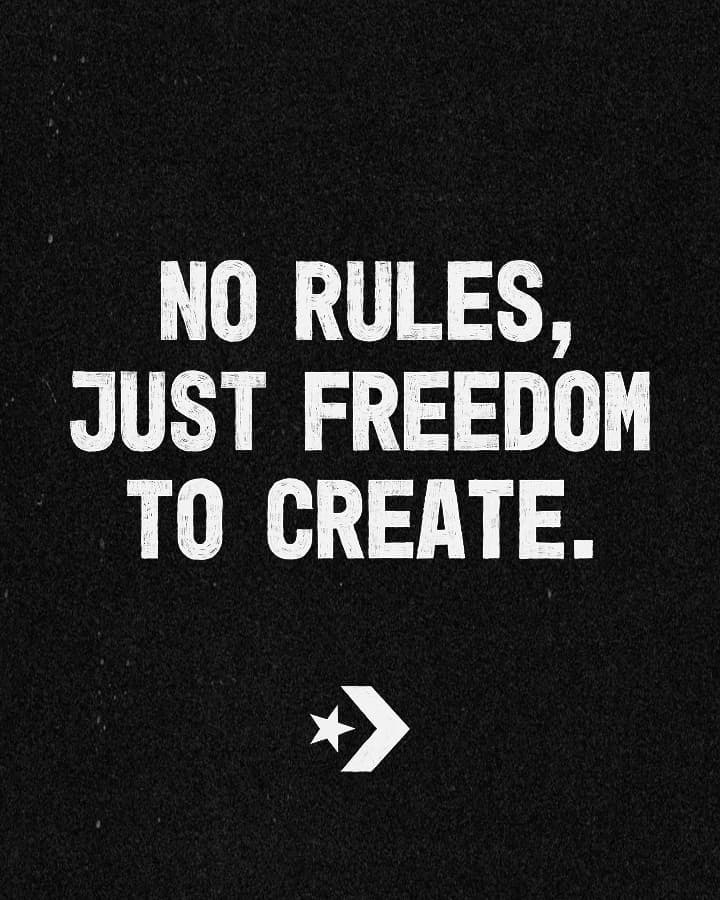 The image displays the bold white text &ldquo;NO RULES, JUST FREEDOM TO CREATE.&rdquo; on a black background with a small star and arrow symbol beneath it.