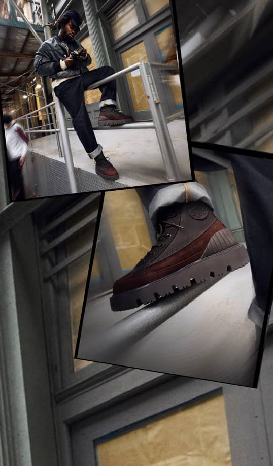 The image shows a person dressed in dark clothing sitting on a metal railing while holding a camera, with an urban industrial background. A close-up highlights their rugged brown and black boots resting on the railing.