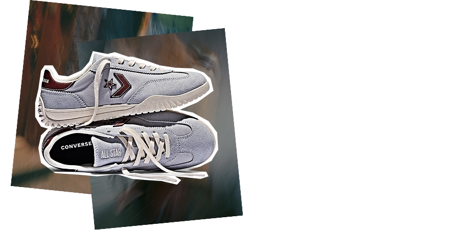 The image shows a pair of light gray Converse sneakers with white laces and dark red accents, placed on two overlapping blurred photographs. One shoe is viewed from the side, displaying the Converse star logo, while the other is shown from above with &ldquo;CONVERSE&rdquo; and &ldquo;ALL STAR&rdquo; visible inside.