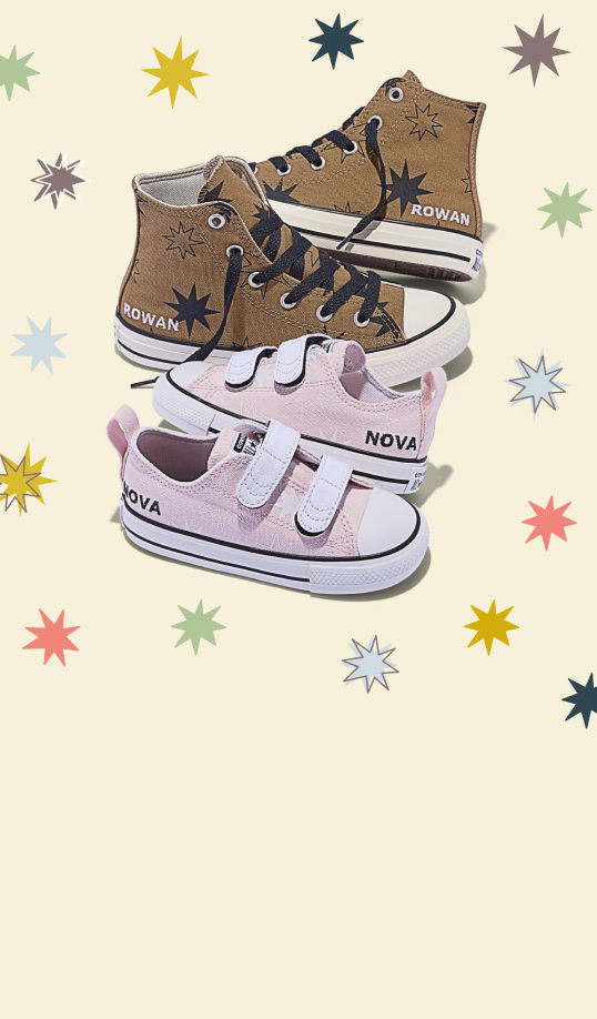 A pair of brown high-top sneakers labeled &ldquo;ROWAN&rdquo; and a pair of pink low-top velcro shoes labeled &ldquo;NOVA&rdquo; are arranged against a pale background. Colorful starburst motifs decorate both the shoes and the surrounding background.